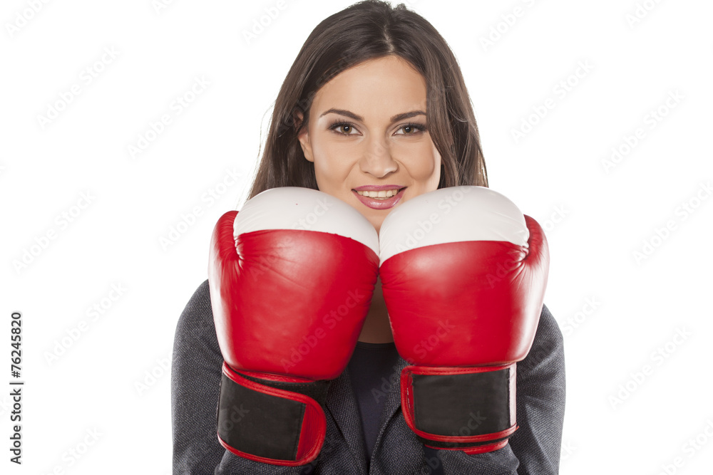 happy business woman with boxing gloves on a white background happy business woman with boxing gloves on a white background
