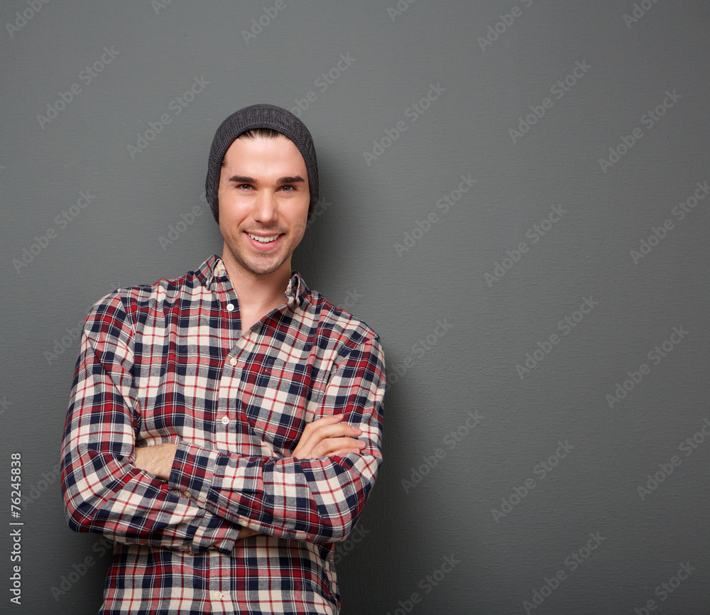 Confident young man smiling with arms crossed Confident young man smiling with arms crossed