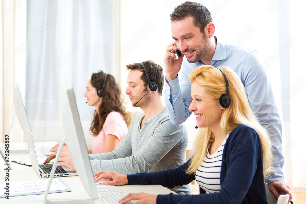 Fototapeta premium Manager training a young attractive people on computer