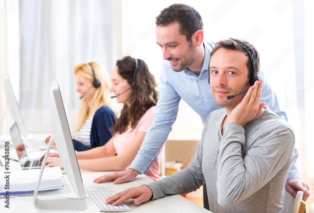 Manager training a young attractive people on computer Manager training a young attractive people on computer