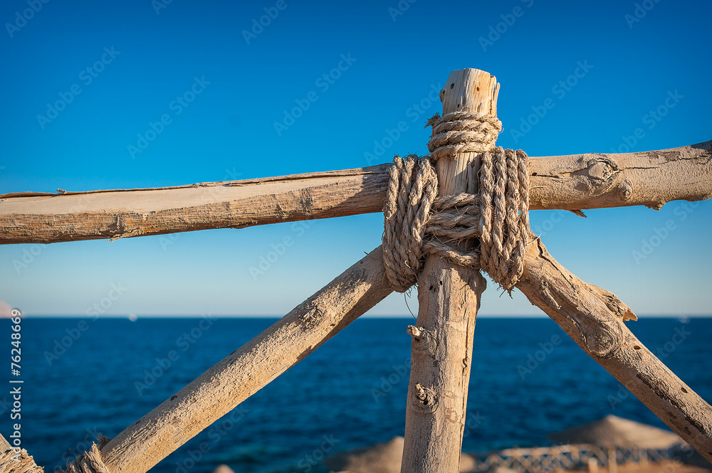 wooden fence element in the background of the sea
