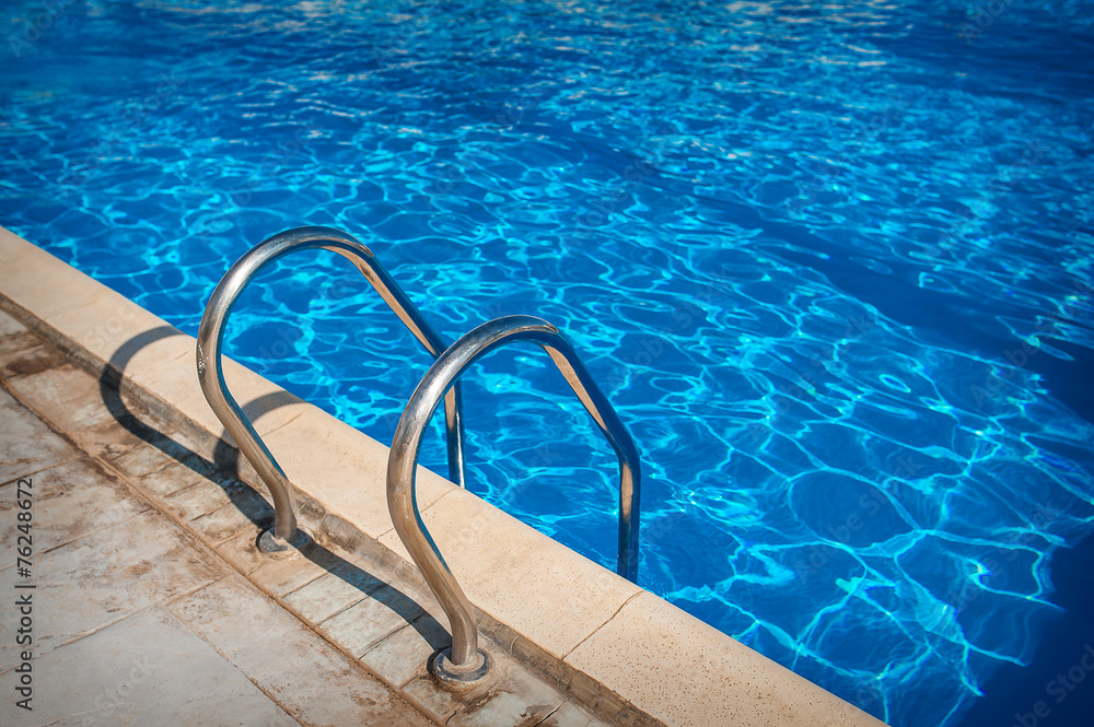 Ladder of a swimming pool. Horizontal shot Ladder of a swimming pool. Horizontal shot