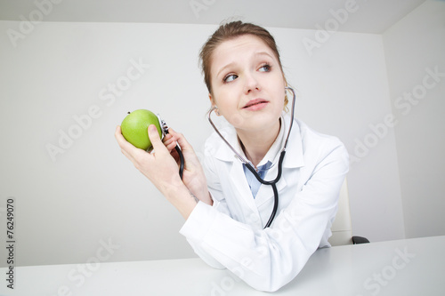 Woman Doctor Recommanding An Apple photo