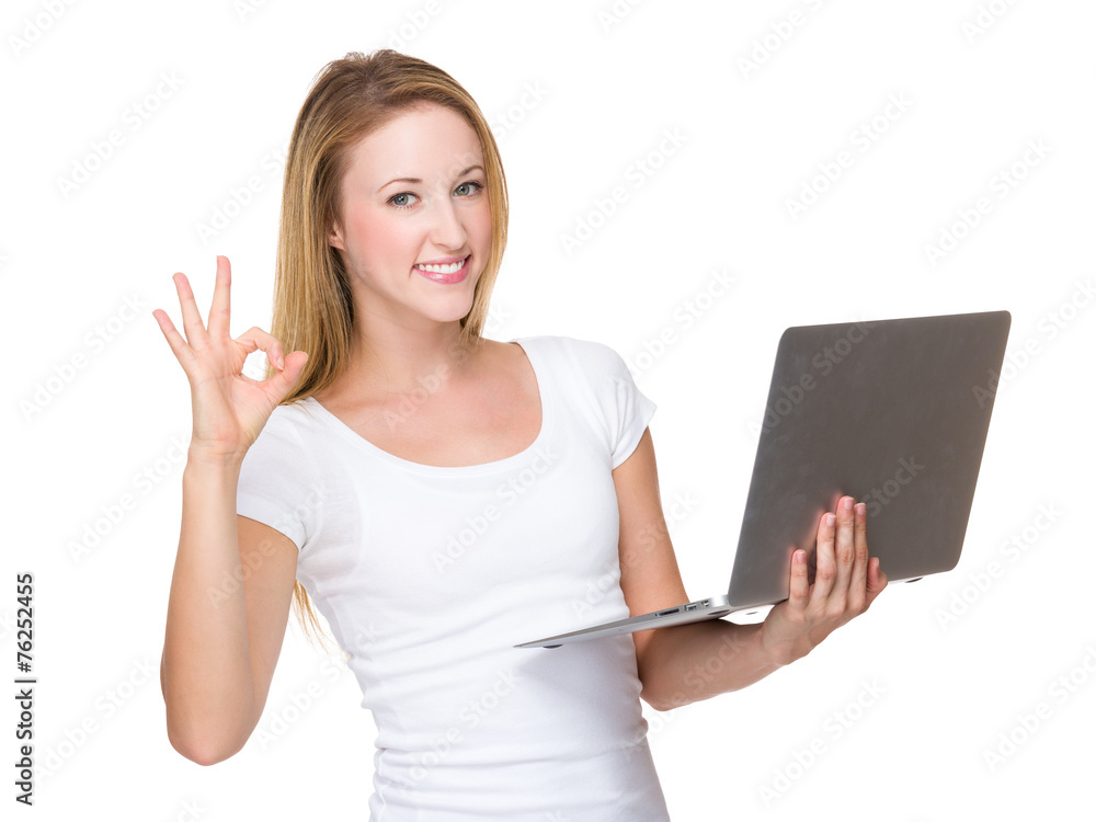 Woman use of laptop and ok sign Woman use of laptop and ok sign