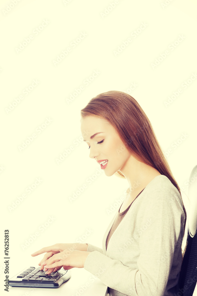 Beautiful woman student is writing on keyboard. Beautiful woman student is writing on keyboard.