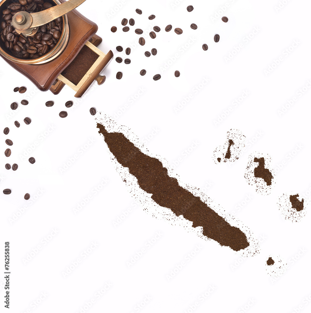 Fototapeta premium Coffee powder in the shape of New Caledonia and a coffee mill.(s