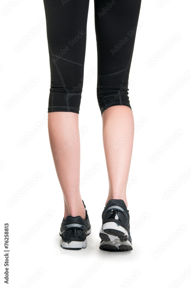 Woman fitness. Runner legs and feet running closeup on shoe Woman fitness. Runner legs and feet running closeup on shoe