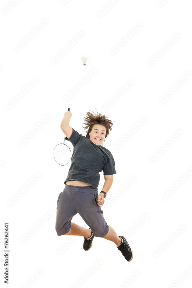 boy holding badminton racket and trying to hit ball
