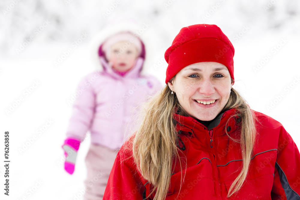 Fototapeta premium portrait of mother with little daughter in winter