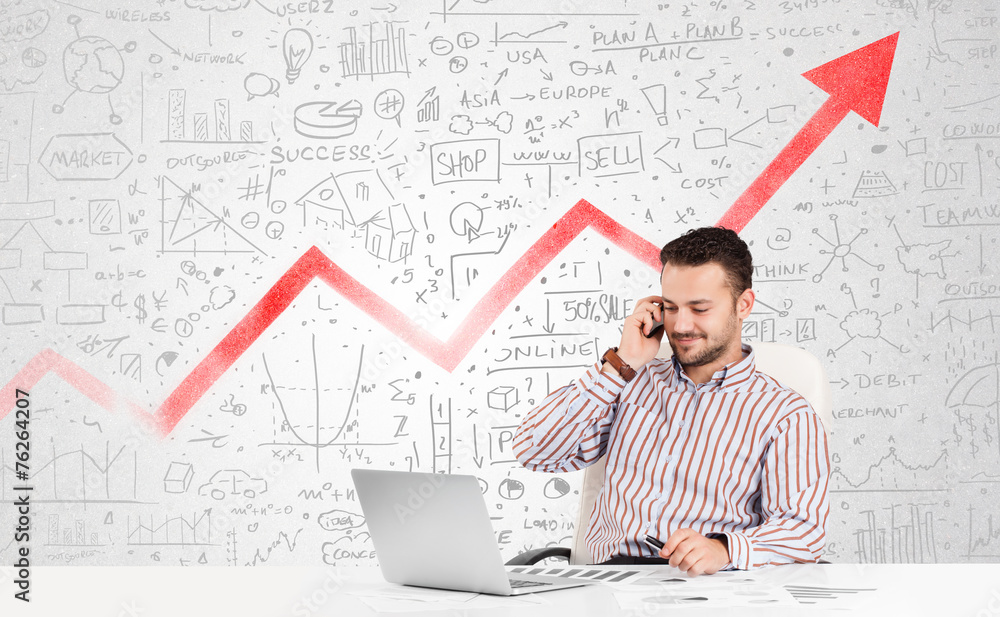 Business man sitting at table with market diagrams Business man sitting at table with market diagrams