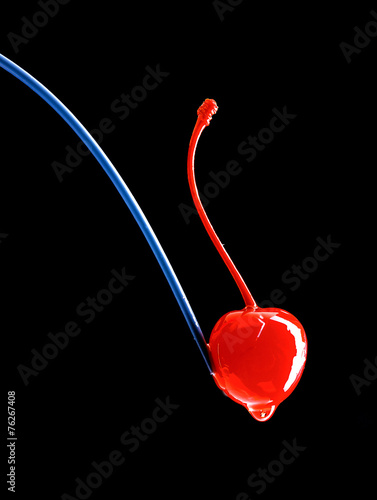 Red cherry on black background