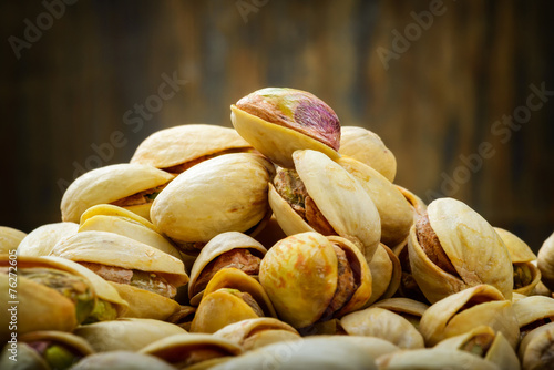 Pistachios on wooden table. Selective focus