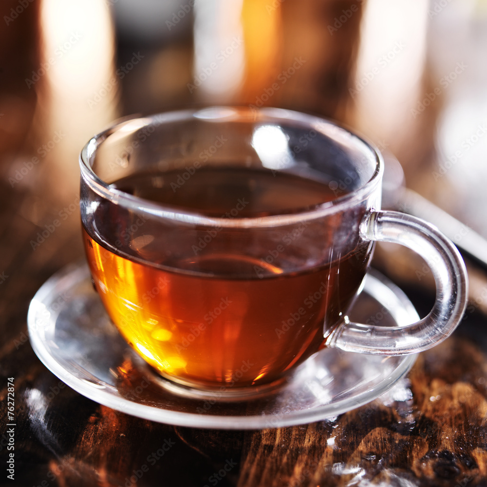 cup of hot tea on wooden table shot with selective focus cup of hot tea on wooden table shot with selective focus