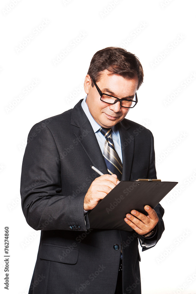 Standing Middle Aged Businessman Writing in File Folder isolated Standing Middle Aged Businessman Writing in File Folder isolated