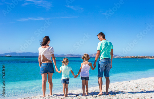 Happy family with two kids during tropical beach vacation