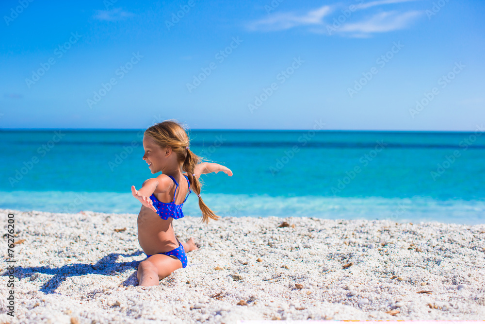 Happy little sporty girl on white tropical beach Happy little sporty girl on white tropical beach