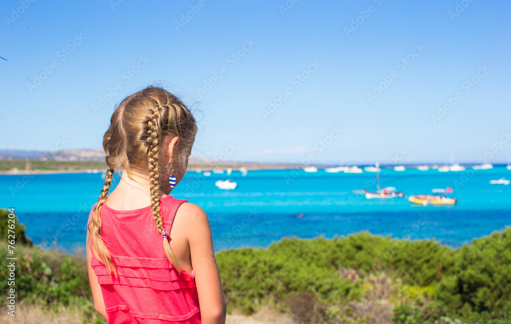 Little adorable girl enjoying beautiful view of turquoise sea Little adorable girl enjoying beautiful view of turquoise sea