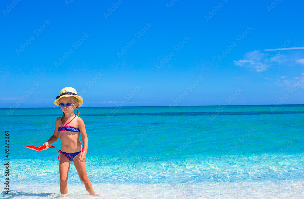 Adorable little girl having fun during beach vacation Adorable little girl having fun during beach vacation