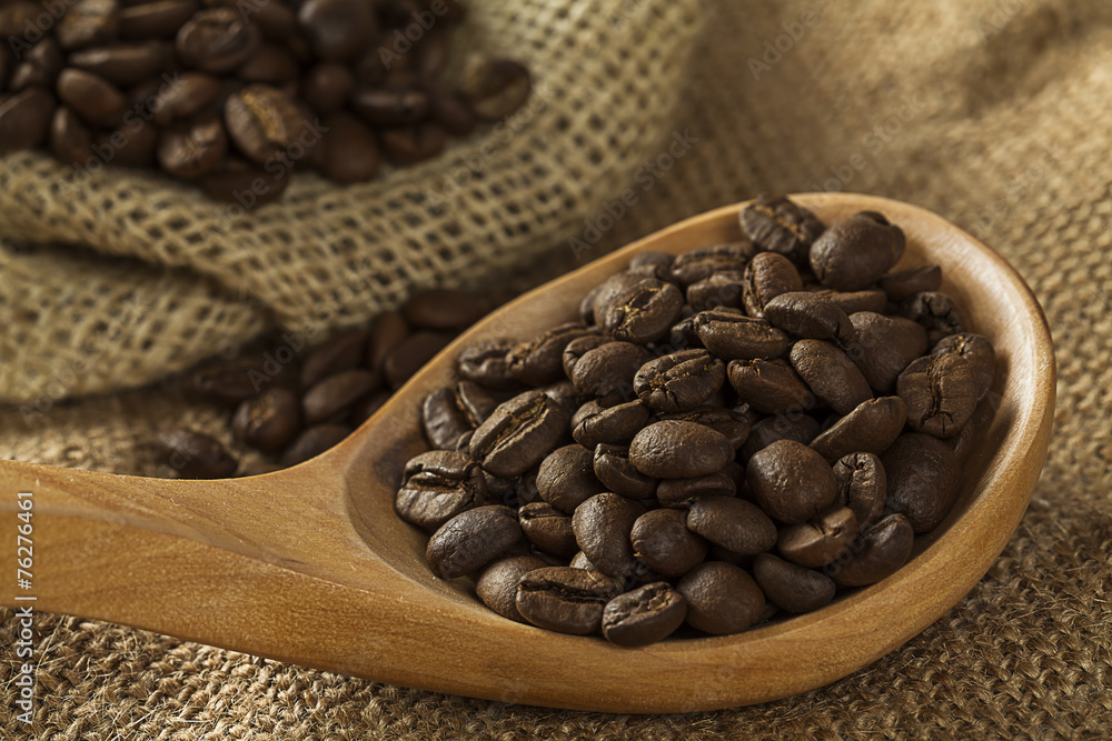 Fototapeta premium Coffee beans on burlap sack and spoon