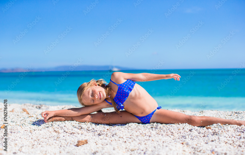Happy little sporty girl on white tropical beach Happy little sporty girl on white tropical beach