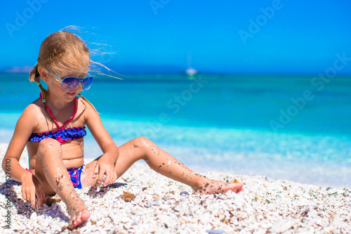 Adorable little girl have fun during beach vacation