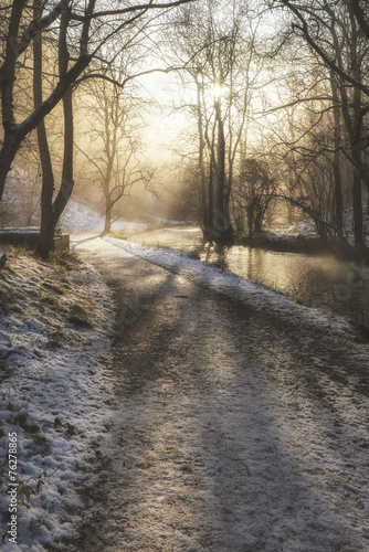 Beautiful Winter snow covered countryside landscape of river flo