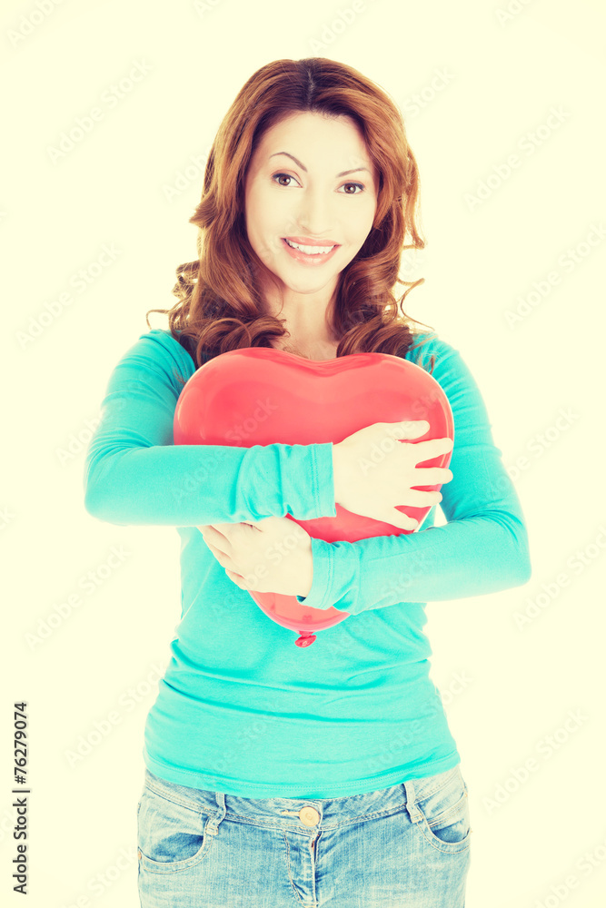 Attractive woman holding a baloon heart. Attractive woman holding a baloon heart.