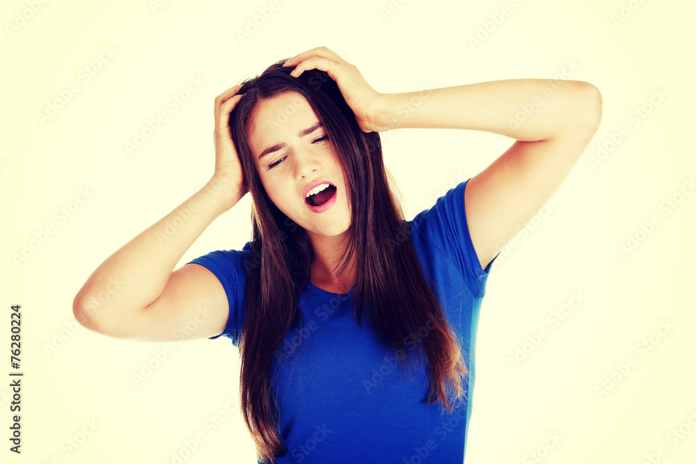 Young woman having terrible headache.