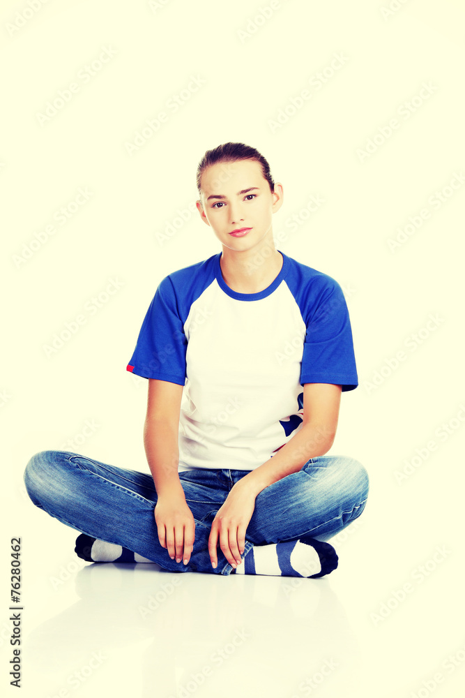 Beautiful young teenage woman sitting. Beautiful young teenage woman sitting.