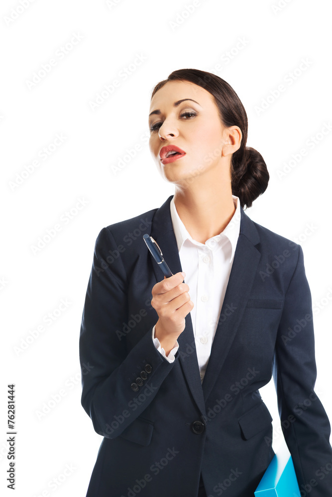 Photo of businesswoman holding pen, looking at the camera Photo of businesswoman holding pen, looking at the camera