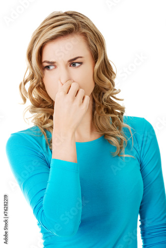 Portrait of a woman clogging nose