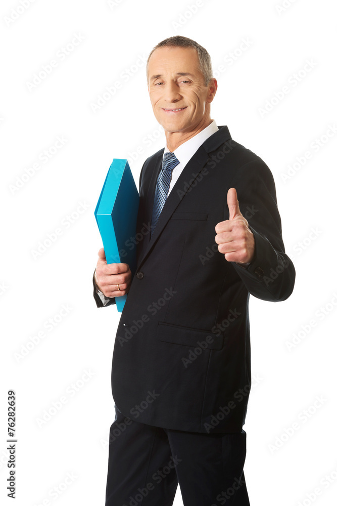 Mature businessman with ok sign holding a binder Mature businessman with ok sign holding a binder