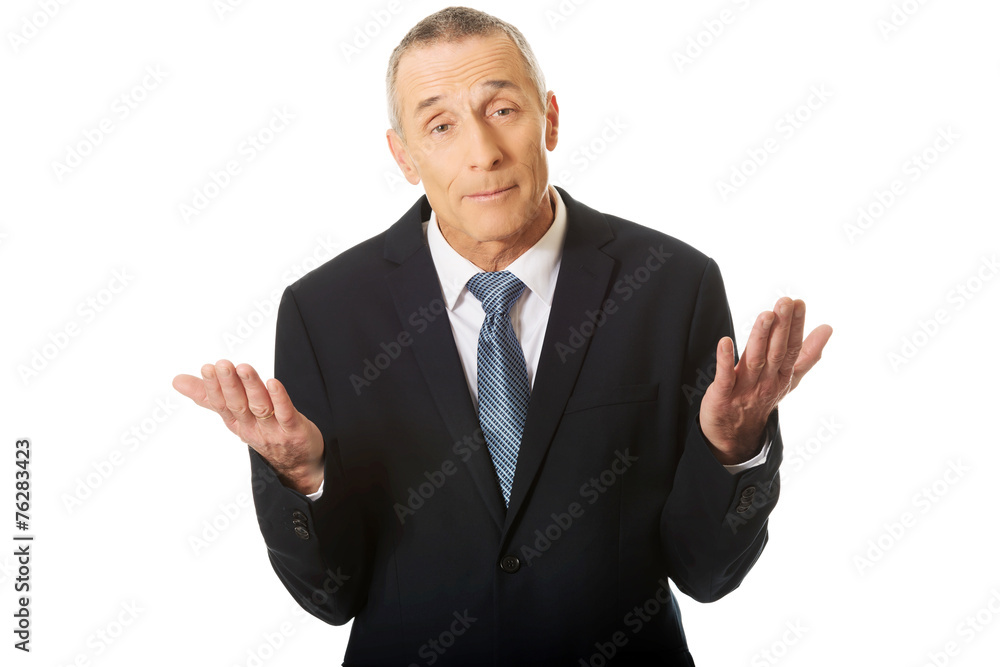 Portrait of businessman making undecided gesture Portrait of businessman making undecided gesture