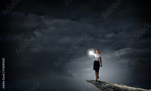 Businesswoman with lantern