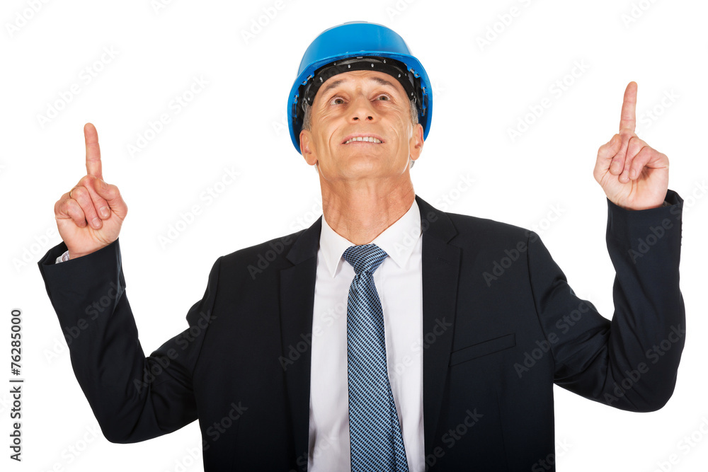 Portrait of businessman engineer pointing up
