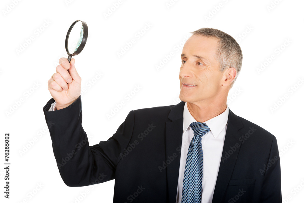 Portrait of businessman with a magnifying glass Portrait of businessman with a magnifying glass