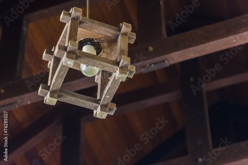 lamp bulp in a wooden bracket cage