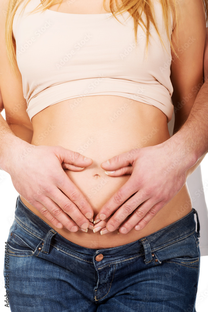 Man embracing her wife's pregnancy belly Man embracing her wife's pregnancy belly