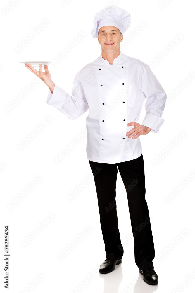 Chef holding white porcelain plate Chef holding white porcelain plate