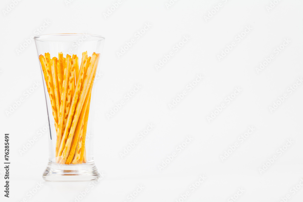 Pretzel snacks in glass over white background. Pretzel snacks in glass over white background.