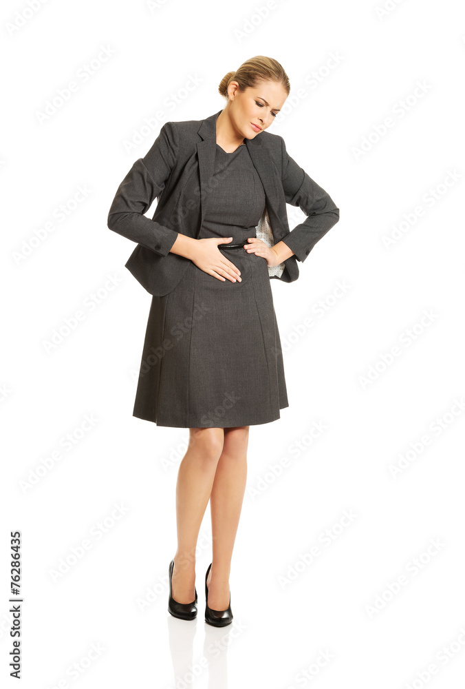 Blonde businesswoman with strong stomachache Blonde businesswoman with strong stomachache