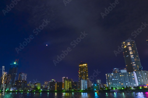 Tokyo riverside cityscape at night.