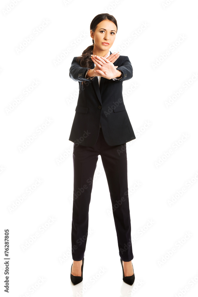 Full length young businesswoman making stop sign Full length young businesswoman making stop sign