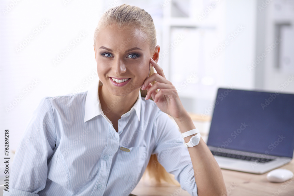 Attractive businesswoman sitting in the office Attractive businesswoman sitting in the office