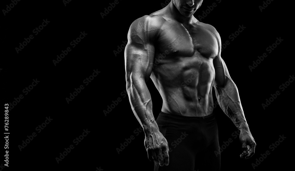 Fit young bodybuilder posing. Black and white