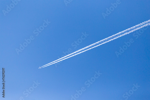 trace of an airplane in the blue sky