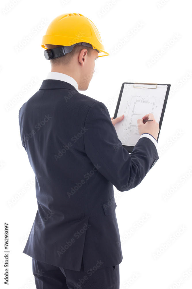 young handsome business man in yellow builder's helmet writing s young handsome business man in yellow builder's helmet writing s