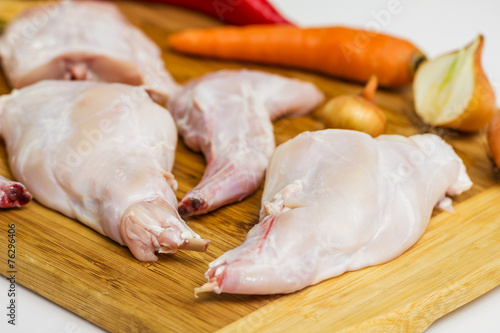 Some pieces of raw rabbit meat with vegetables and spices