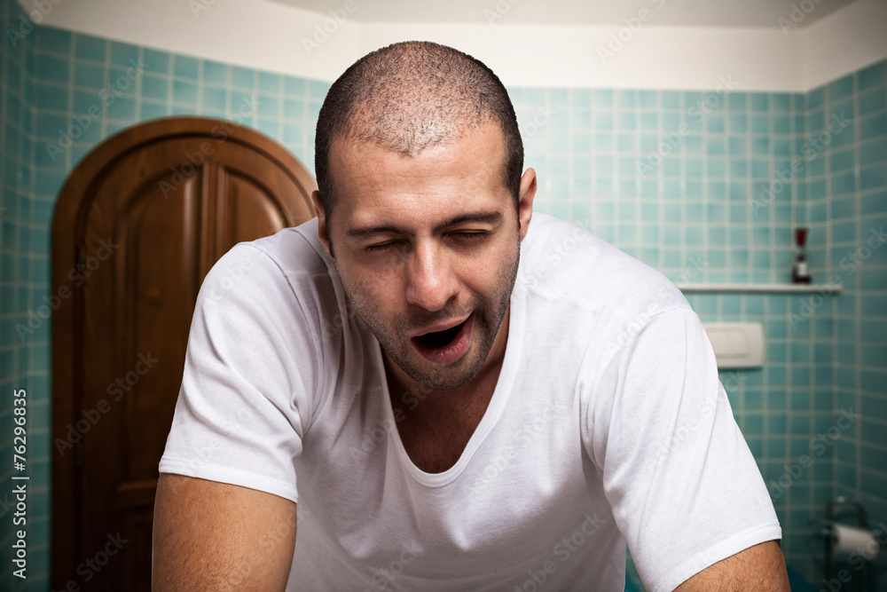 Tired man looking in the mirror in the morning Tired man looking in the mirror in the morning