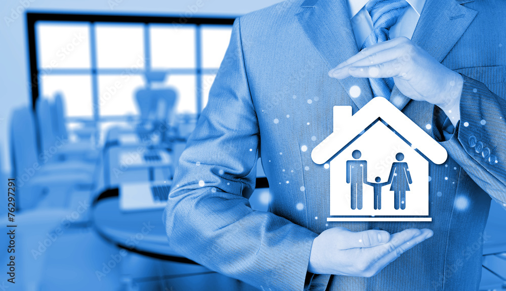 businessman protecting family in home with hands businessman protecting family in home with hands